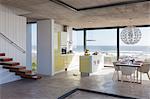 Modern kitchen and dining room overlooking ocean