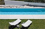 Lounge chairs by modern lap pool