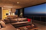 Sofa and dining table in modern living room overlooking ocean