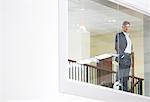 Businessman looking out glass window