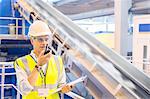 Supervisor using walkie-talkie in recycling center