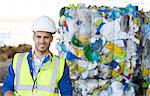 Worker smiling in recycling center