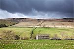 Clouds gathering over rural fields