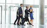 Business people walking in office lobby