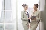 Businesswomen using digital tablet in office