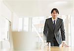 Businessman standing at conference table