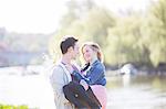 Man carrying girlfriend along river