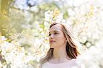 Woman under tree with white blossoms