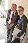 Businessmen smiling on outdoor steps