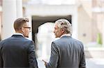 Businessmen talking on city street