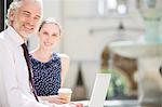 Business people using laptop outdoors