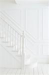 Banister and staircase in white foyer