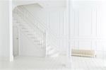 White staircase and walls in ornate house