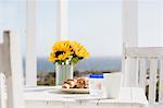 Sunflowers and croissants on patio table