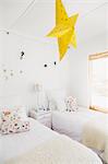 Yellow star lamp and wall decorations in childrens bedroom