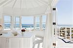 White bedroom overlooking ocean