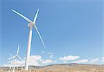 Wind turbines spinning in rural landscape