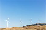 Wind turbines spinning in rural landscape