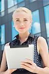 Young woman using digital tablet outdoors