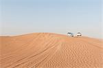 Sports utility vehicles driving across desert