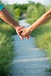 Couple holding hands, close-up