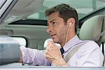 Man using earphone headset while driving