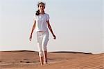 Girl with forlorn expression alone in desert