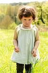 Little girl standing in meadow, portrait