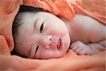 Newborn Asian baby girl on bed, 7 days after birth