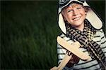 Smiling boy with wooden plane