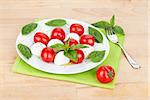 Caprese salad plate on wooden table