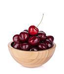 Ripe cherries in a wooden bowl. Isolated on white background