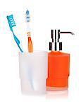 Two colorful toothbrushes and liquid soap. Isolated on white background