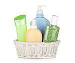 Cosmetics bottles in basket. Isolated on white background