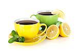 Two colorful cups of tea with lemon and mint. Isolated on white background