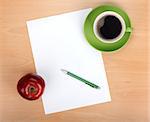 Blank paper with pen, coffee cup and red apple on wood table