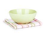 Salad bowl over kitchen towel. Isolated on white background