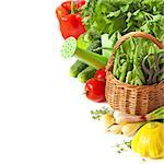 Fresh kitchen garden vegetables and watering can on a white background.