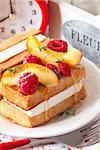 Sweet Belgian waffle with nectarine, berries and hohey for breakfast.