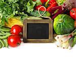 Fresh ripe vegetables with chalk blackboard for text on a white background.