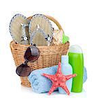 Beach items in basket. Isolated on white background