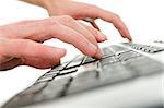 Closeup of  young man  hands typing on computer keyboard. Shallow depth of field.