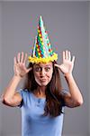 Party clown hat girl showing funny faces