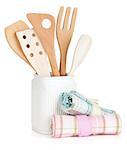 Kitchen utensils in holder and towels. Isolated on white background