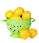Fresh ripe lemons in colander. Isolated on white background
