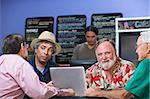 Cheerful man with diverse friends in cafe