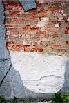 Old broken weathered wall of bricks