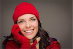 Happy Mixed Race Woman Wearing Winter Hat and Gloves on Gray Background.