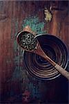 Green tea leaves (gun powder) on a wooden tea spoon