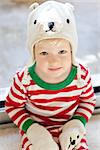 cute adorable toddler wearing warm hat and mittens